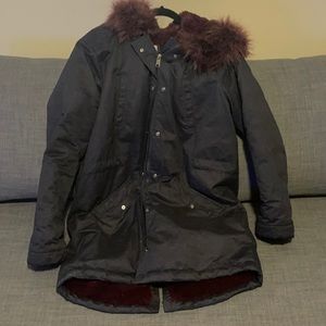 Navy blue winter coat, with purple fur inside.